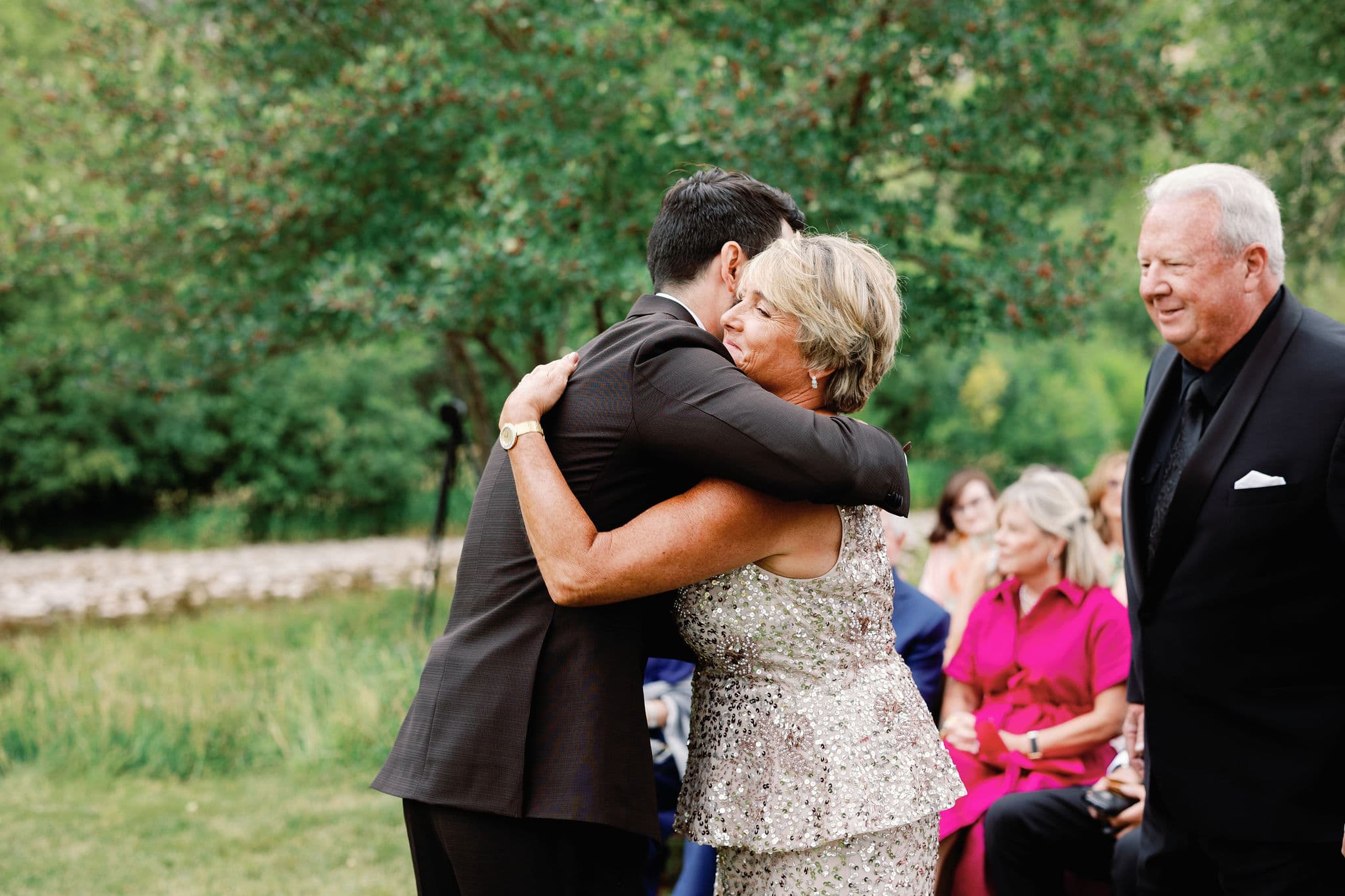 Groom holding his mother in a long embrace after the ceremony