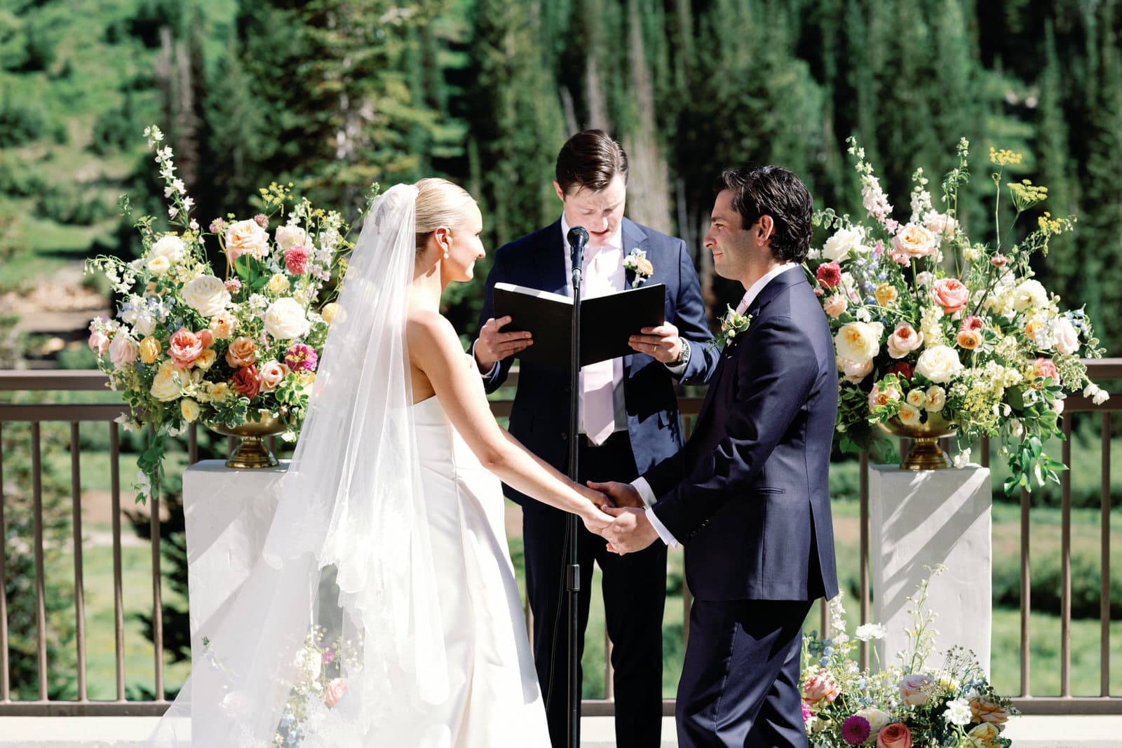 A couple at the altar during their wedding ceremony, photographed by Christopher Cook