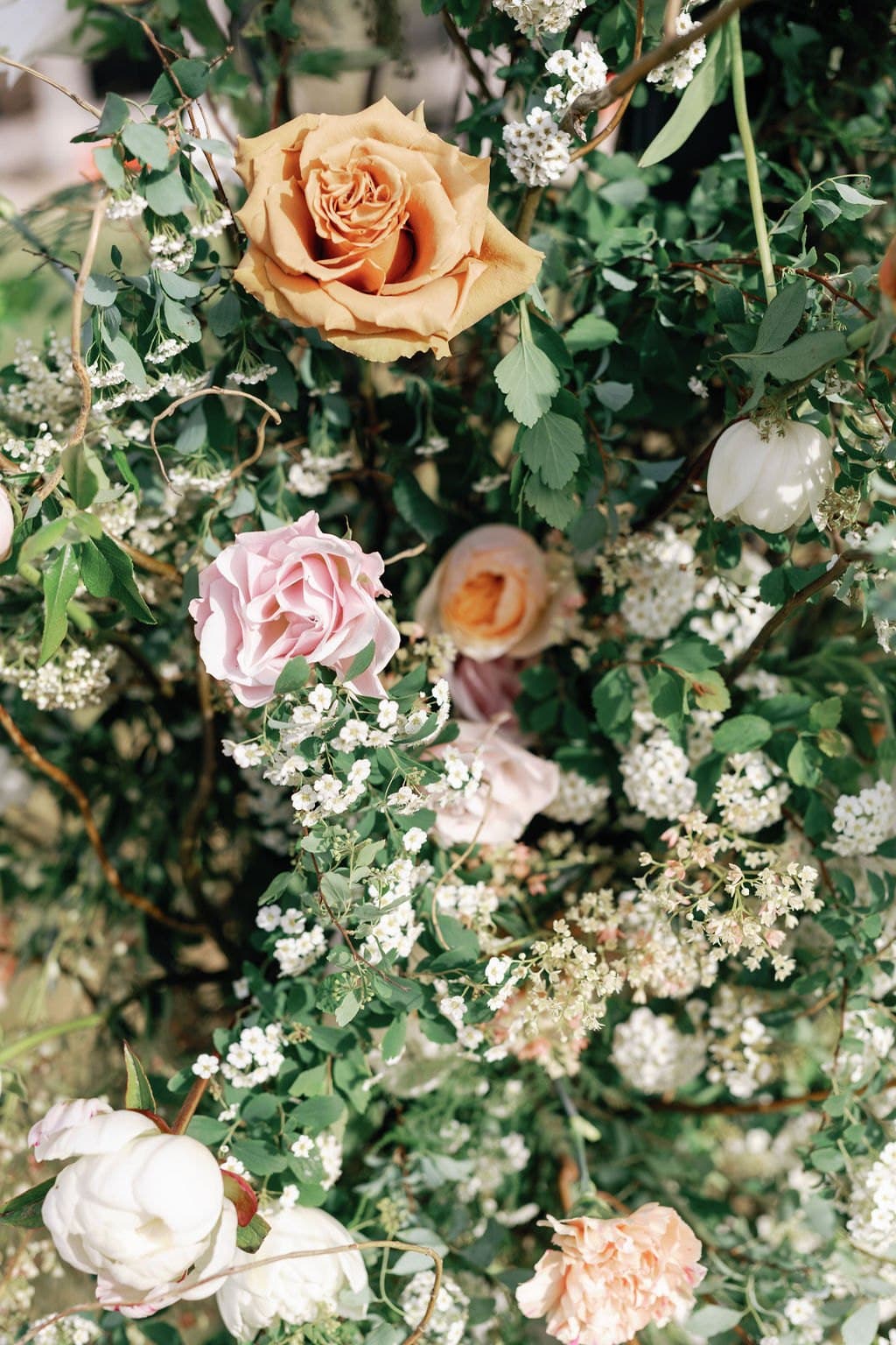 Peach and blush roses in a ceremony floral installation
