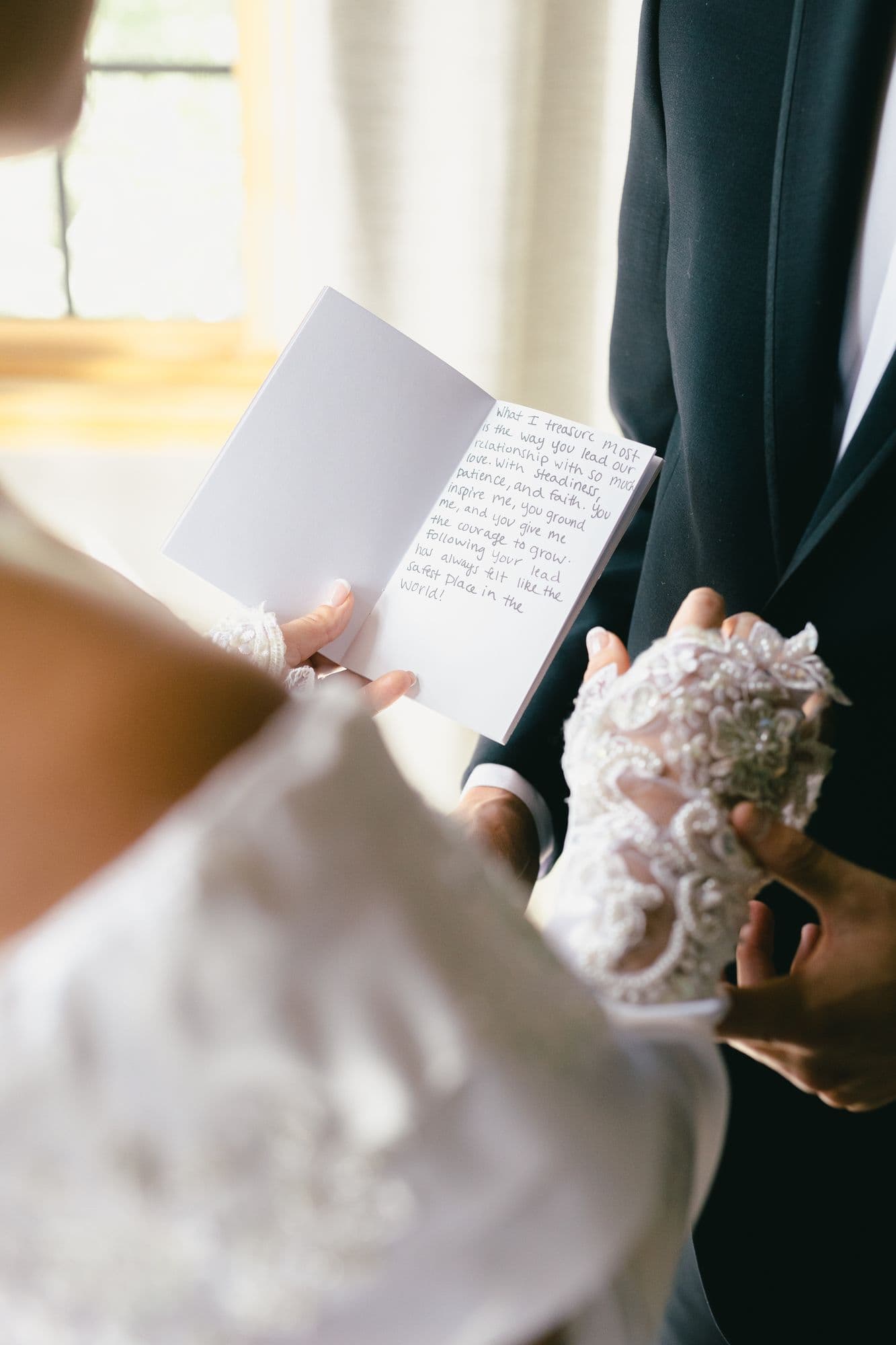 Marita reading her letter to Kyle in lace opera gloves, her bouquet held against her gown