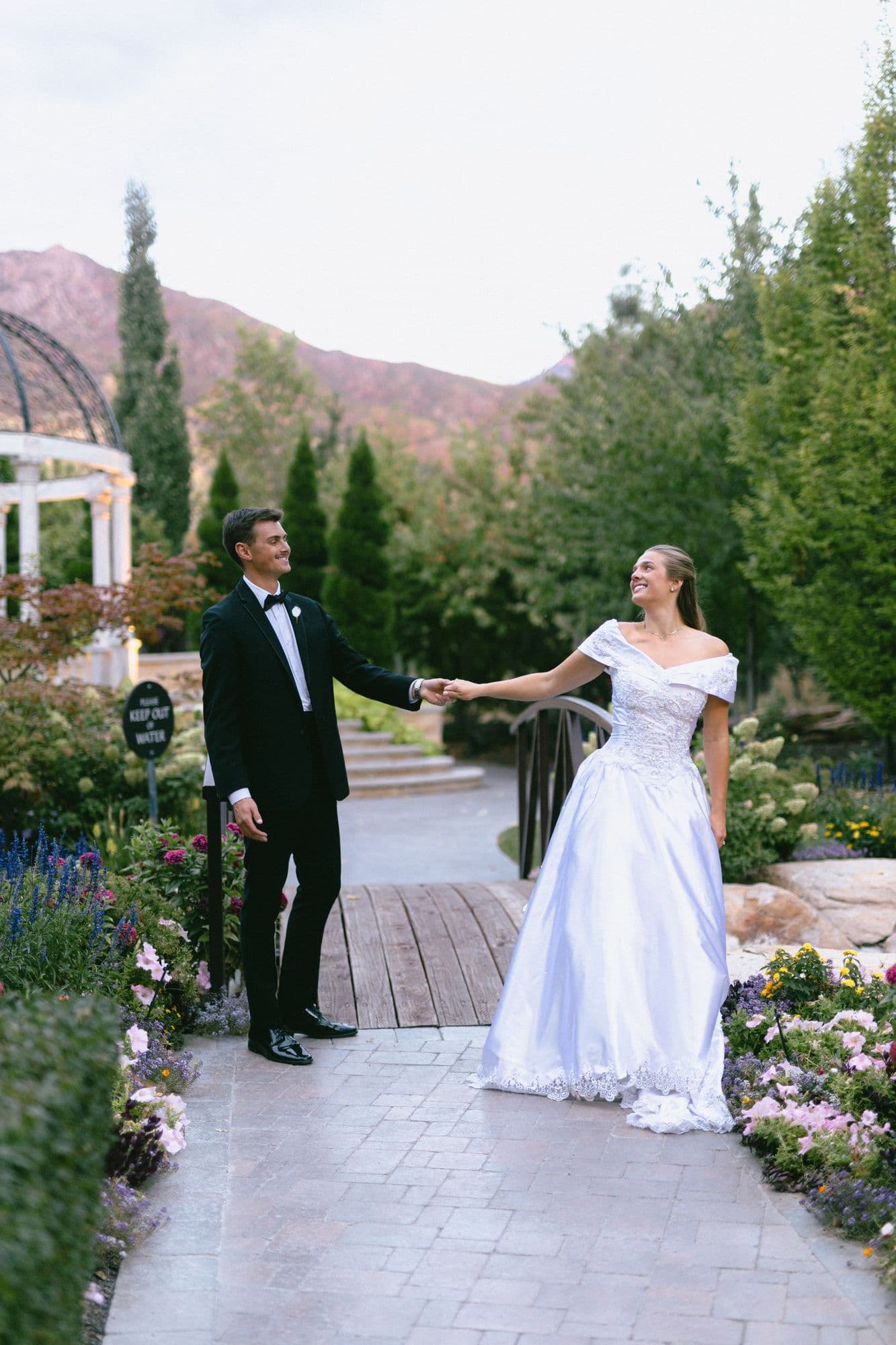 Kyle and Marita at golden hour with the Wasatch mountains turning pink behind the garden