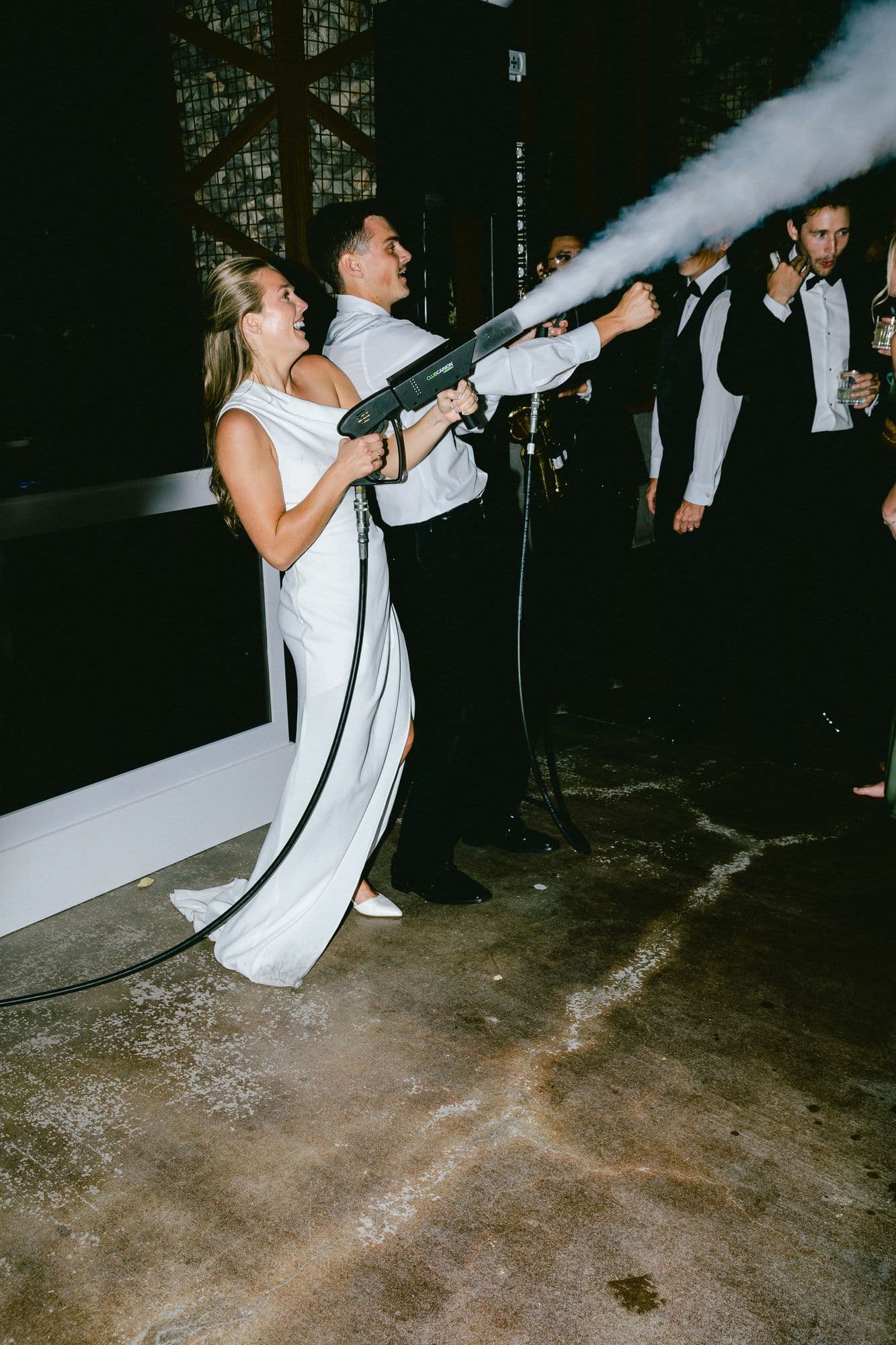 Marita firing a confetti cannon over the dance floor at the end of the night