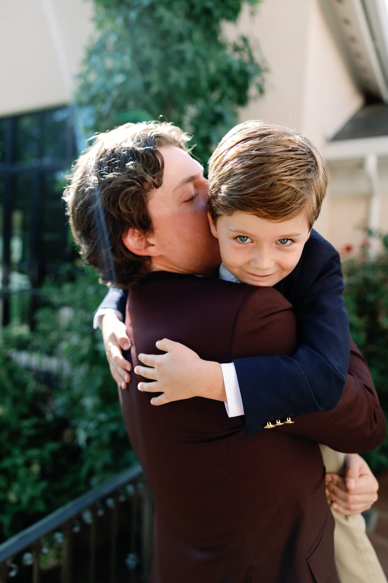 Jake hugging the ring bearer, who looks straight at the camera