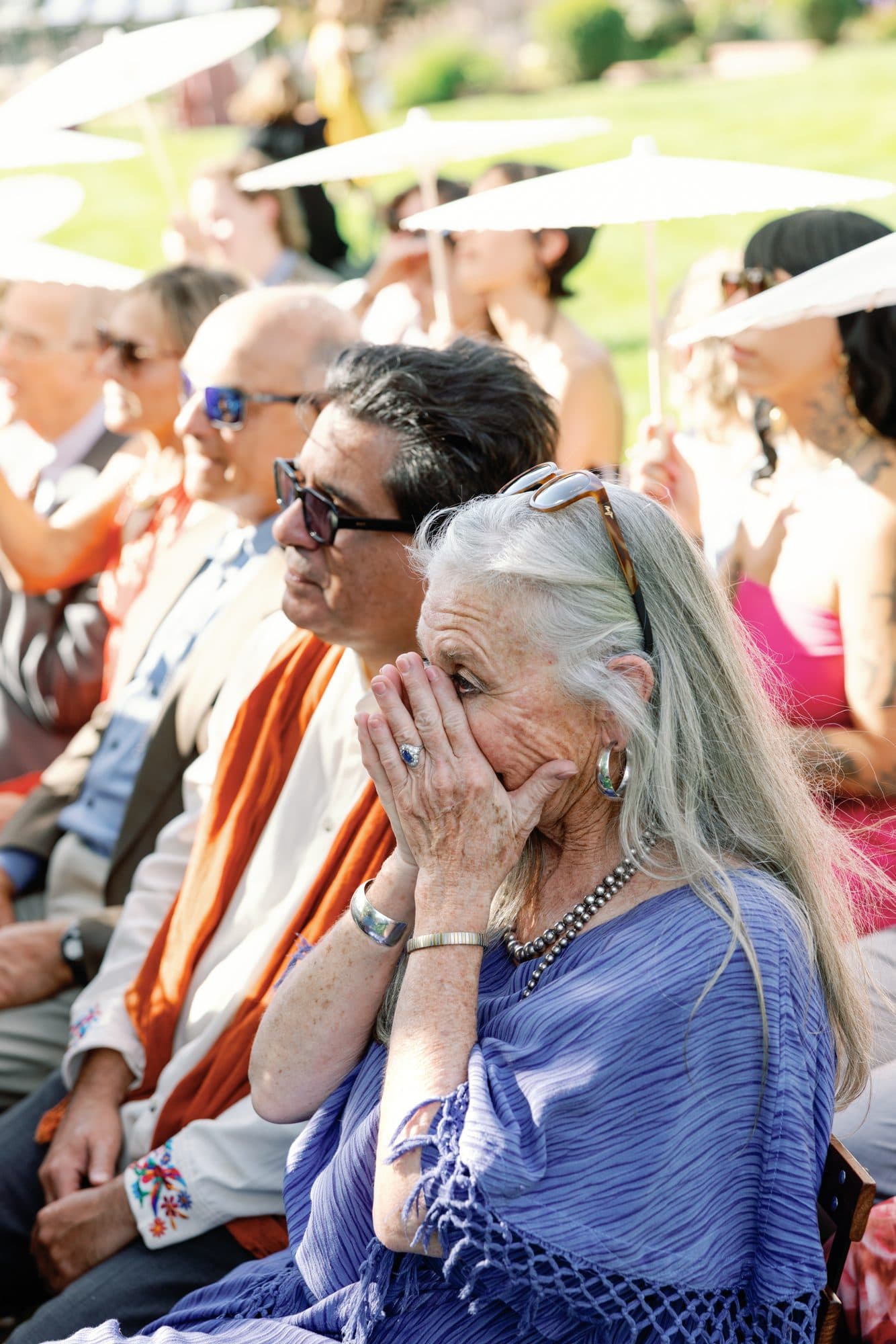 A guest in the front rows in tears during the ceremony, her hands over her mouth