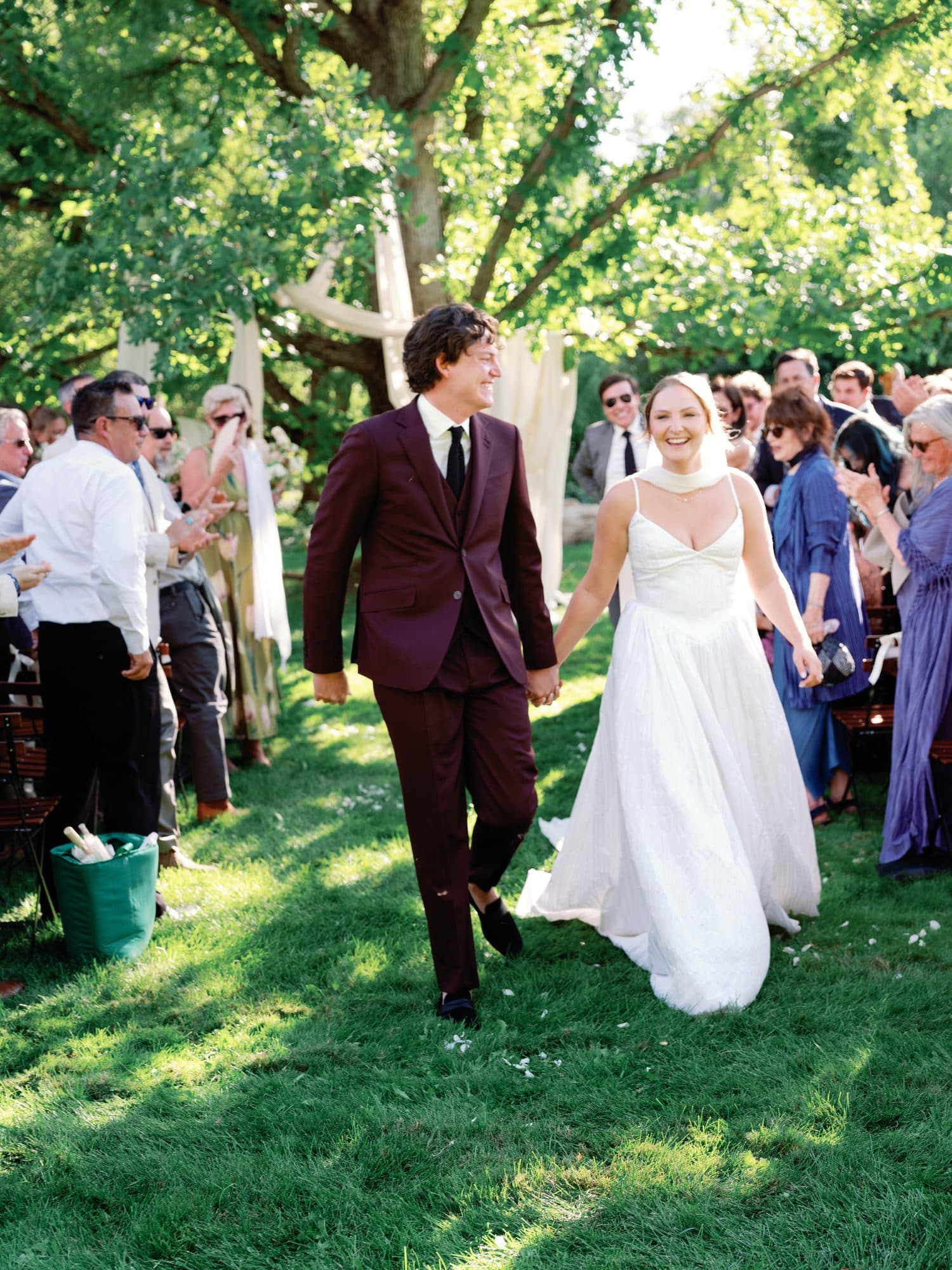 Lauren and Jake laughing as they walk back up the aisle as husband and wife