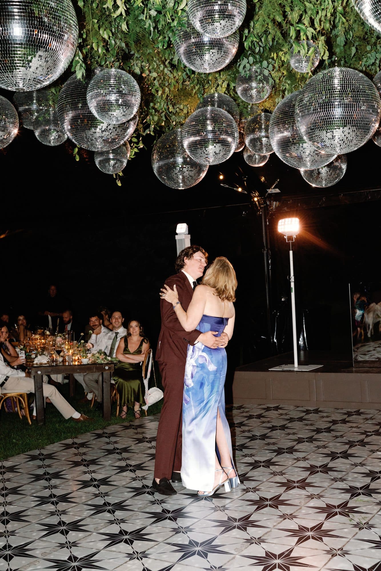 Jake dancing with his mother on the star-tiled floor beneath the disco balls