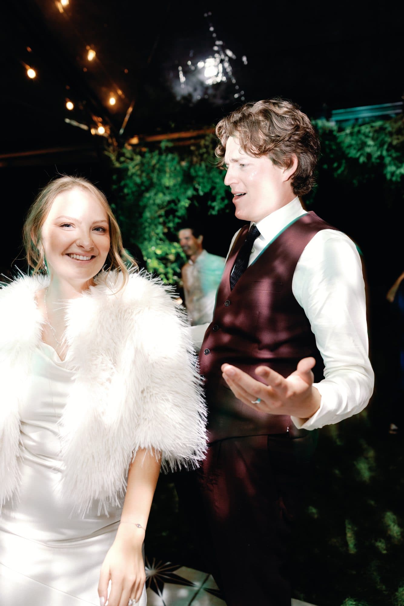 Lauren in a white feathered jacket on the dance floor with Jake beside her