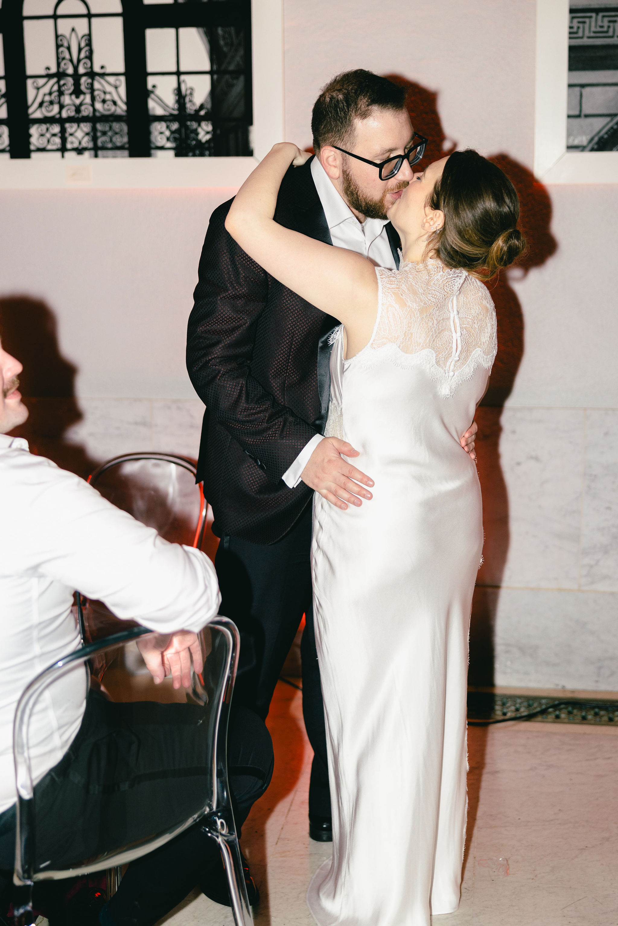 Bride and groom sharing a kiss at the reception, editorial wedding photography by Christopher Cook