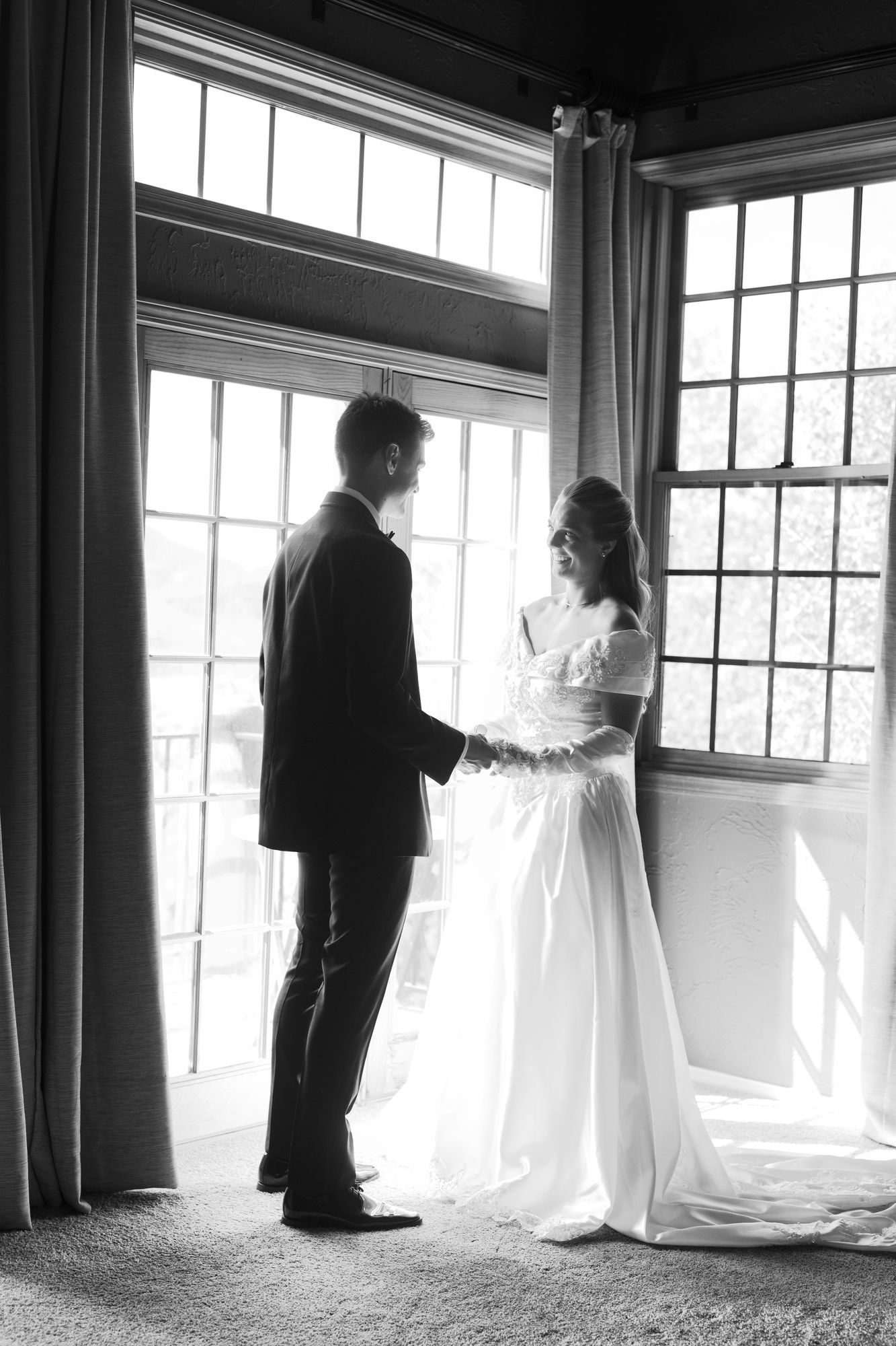 Kyle and Marita’s first look at a tall window, photographed in black and white