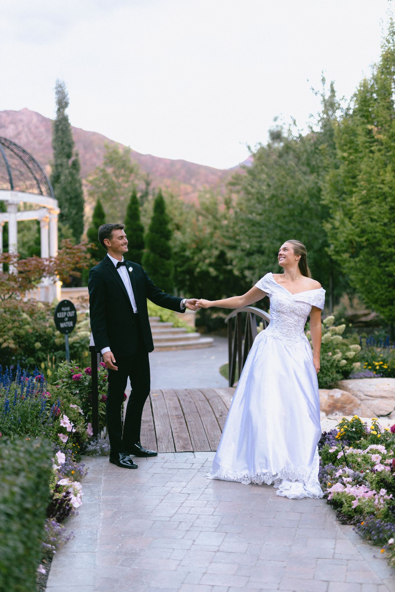 Kyle and Marita at golden hour with the Wasatch mountains turning pink behind the garden