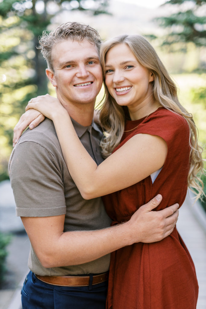 Captivating couple shares a romantic moment during their engagement shoot at the stunning Silver Lake, located in the breathtaking Big Cottonwood Canyon near Salt Lake City